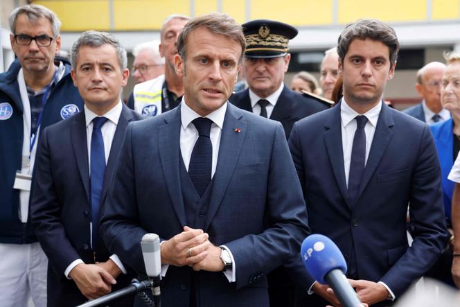 French President Emmanuel Macron, flanked by French Education and Youth Minister Gabriel Attal and French Interior Minister Gerald Darmanin, talks to the press after a teacher was killed and two others severely wounded in a knife attack in Arras, northeastern France on October 13, 2023.