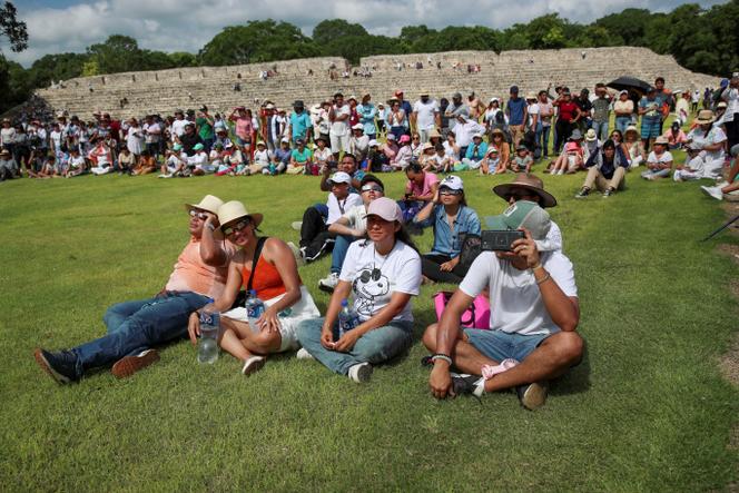 People gather to observe a solar eclipse from Edzna archeological site in Campeche state, Mexico, on October 14, 2023.
