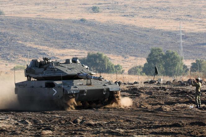 An Israeli Merkava tank drives into position in the north of Israel near the border with Lebanon on October 15, 2023.