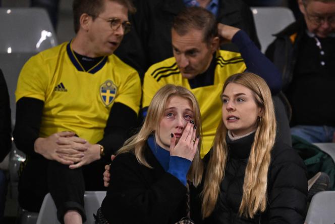 Swedish supporters react as they wait in the stand during the Euro 2024 qualifying football match between Belgium and Sweden at the King Baudouin Stadium in Brussels on October 16, 2023, after an 'attack' that targeted Swedish citizens in a street of Brussels.
