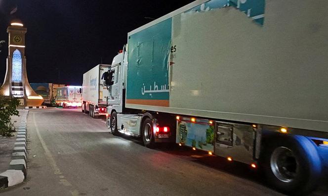 An Egyptian convoy of humanitarian aid trucks waits for permission to cross the border at Rafah, Egypt, on October 17, 2023.