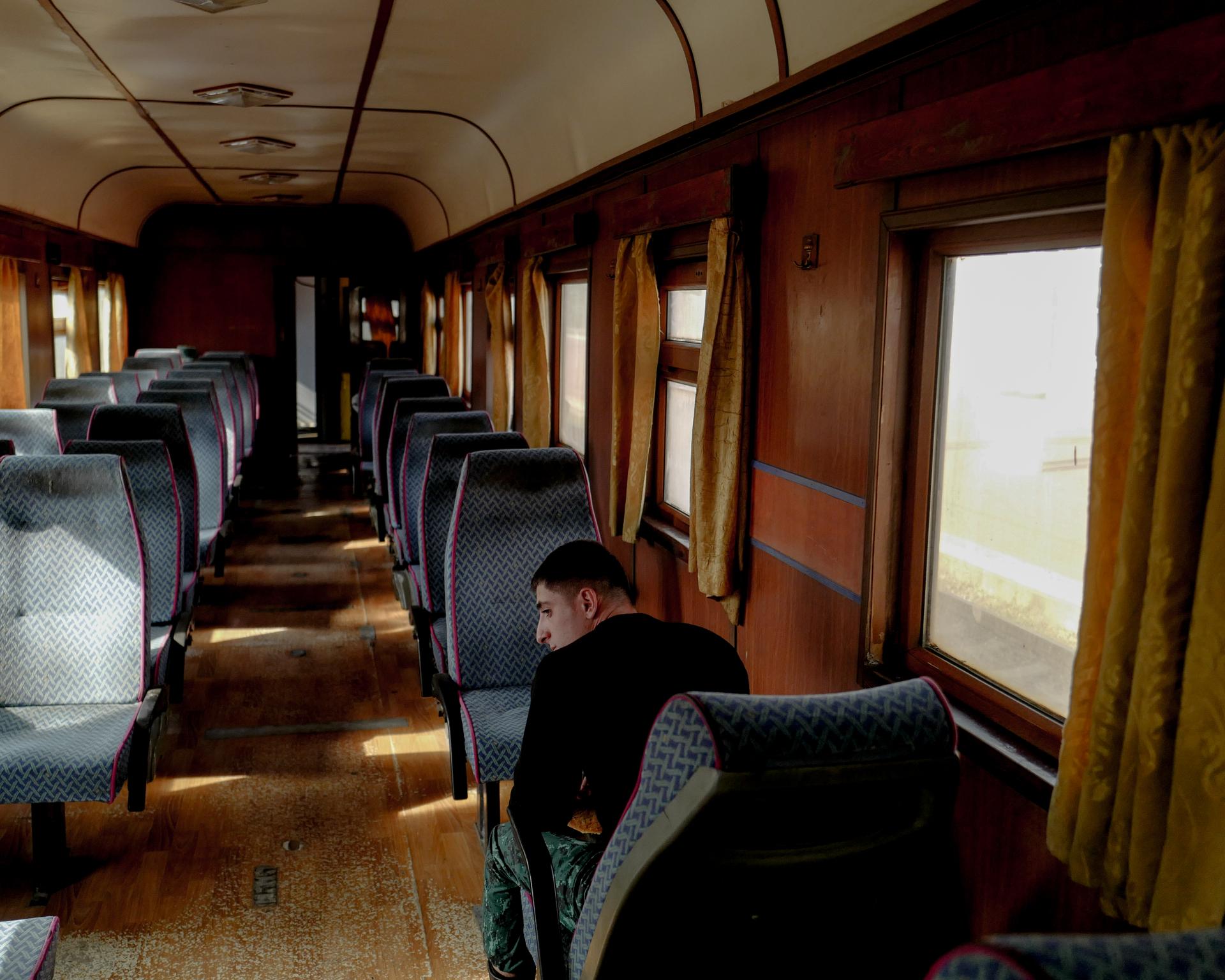 An Azerbaijani soldier awaits the departure of a train at Nakhchivan station, in Azerbaijan, on October 11, 2023.