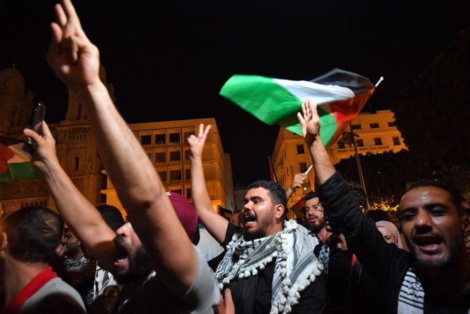 Tunisian protestors shout slogans and wave Palestinian national flags during an anti-Israel demonstration in front of the French ambassy in Tunis on October 17, 2023. 