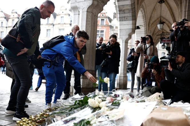 A local resident lays a flower as he attends the funeral ceremony for French schoolteacher Dominique Bernard at the town hall in Arras (northern France), on October 19, 2023.