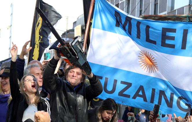 Javier Milei holds a chainsaw next to Carolina Piparo, candidate for governor of Buenos Aires province, at an election rally in Buenos Aires on September 25, 2023.