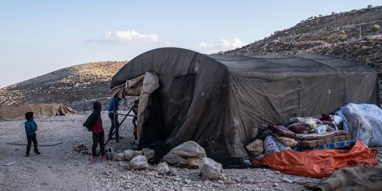 VIRGINIE NGUYEN HOANG/HUMA FOR LE MONDE DUMA, West Bank: Muhammad's children play in front of their temporary tent home in Duma. Last week, Muhammad Zawahra and his family left their Bedouin village of Ein Rashash fearing an imminent settler attack. They have now settled on a plot of land in the town of Duma where Muhammad is trying to build a house, October 19, 2023. Virginie Nguyen Hoang for Le Monde.