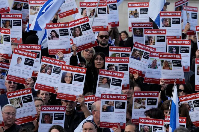 Israeli supports show placards with the faces and names of people believed to be taken hostage and held in Gaza, during a protest in Trafalgar Square, London, Sunday, October 22, 2023.