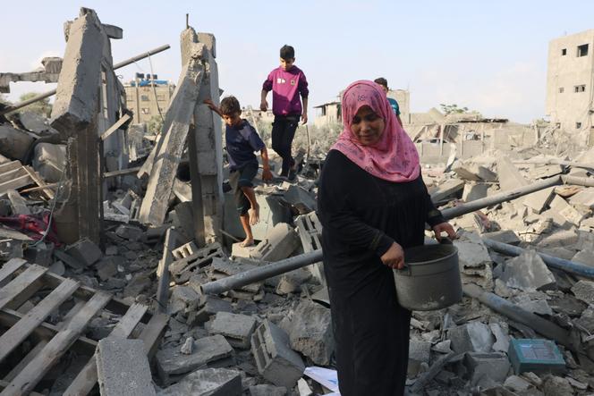 Palestinians inspect the damage after overnight Israeli strikes on Rafah in the southern Gaza Strip on October 22, 2023.