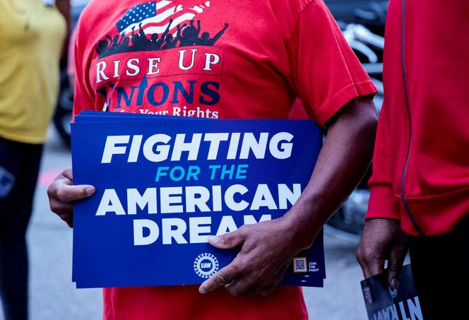 A United Auto Workers union member holds a sign outside Stellantis Sterling Heights Assembly Plant, to mark the beginning of contract negotiations in Sterling Heights, Michigan, U.S. July 12, 2023.