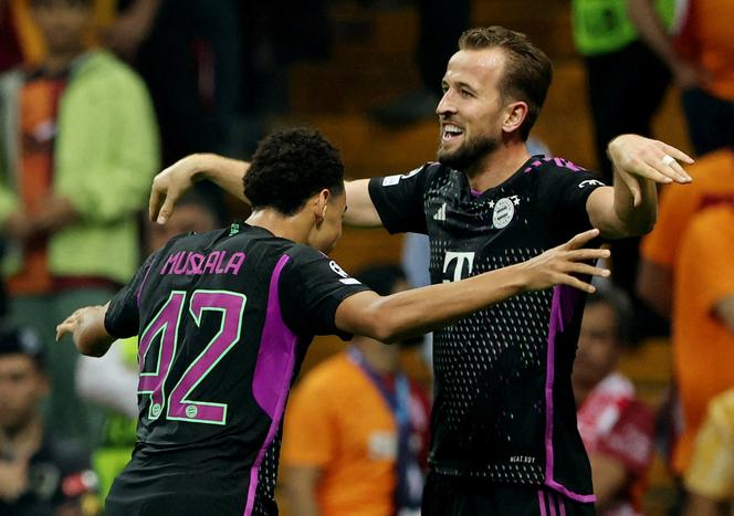 Bayern Munich's Jamal Musiala celebrates scoring their third goal with Harry Kane.