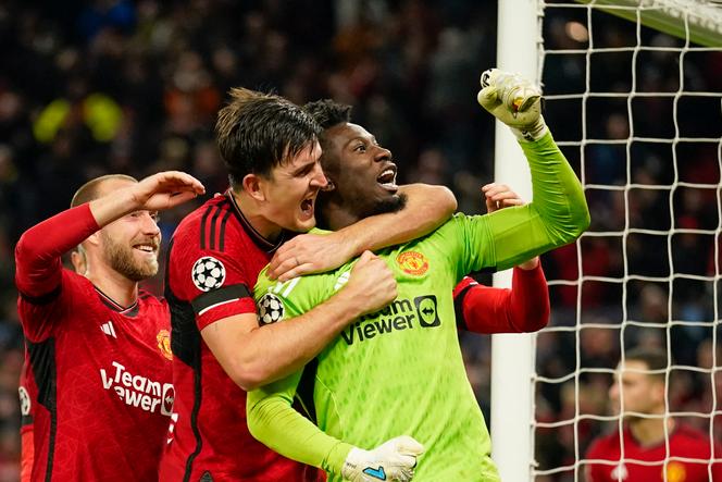 Manchester United's goalkeeper Andre Onana, right, celebrates with teammates after makes a save penalty shoot during the Champions League group A soccer match between Manchester United and Copenhagen at the Old Trafford stadium in Manchester, England, Tuesday, October 24, 2023.