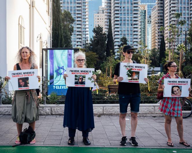 Portraits of the missing and hostages held up by their relatives in front of the Israeli Ministry of Defense in Tel Aviv, October 19.