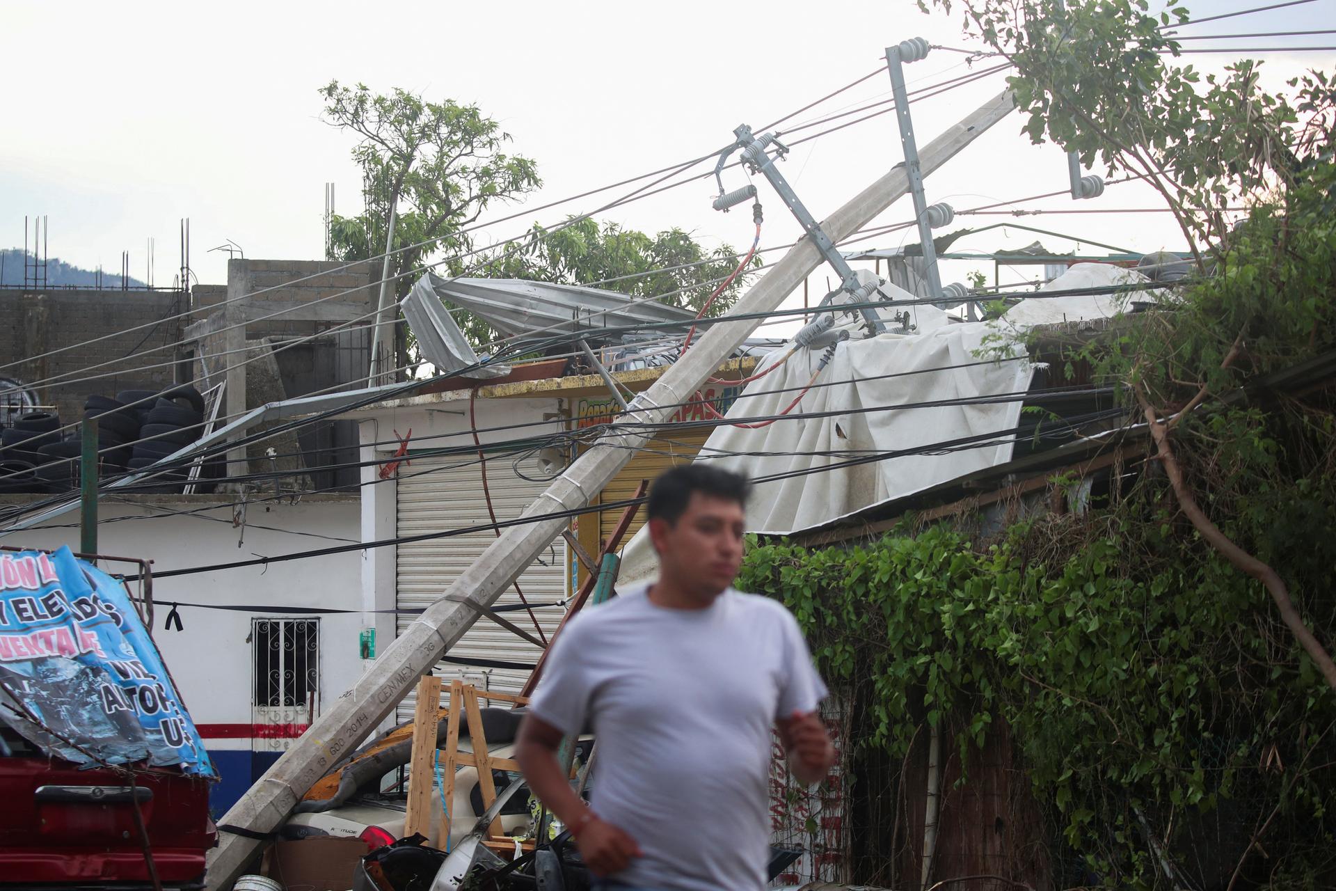 A man near the entrance to Acapulco after Hurricane Otis, in the Mexican state of Guerrero, Mexico, October 25, 2023.