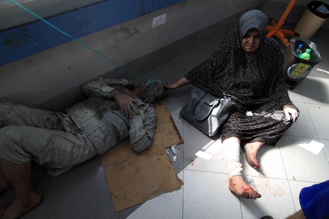 Members of a family who were injured in the bombardment of their home, at Al-Shifa hospital in Gaza City on October 18, 2023.