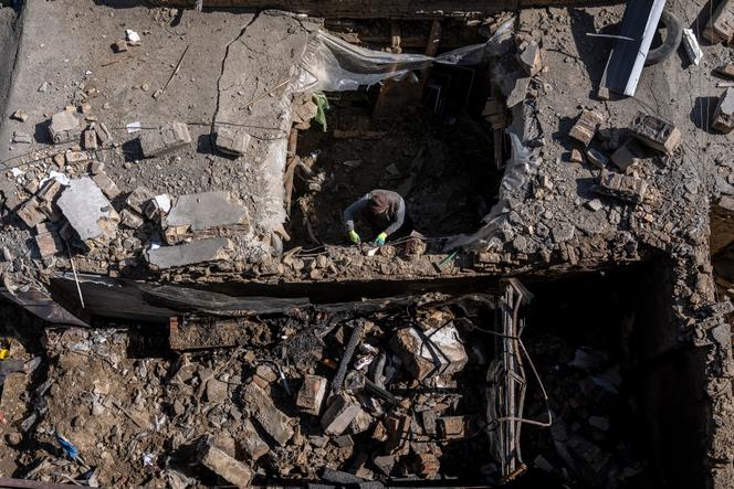 An Afghan man inspects the site of the explosion in a sports club, in the west of Kabul, Afghanistan, Friday, October 27, 2023.