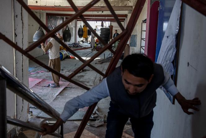 Afghan men remove the site of the explosion in a sports club, in the west of Kabul, Afghanistan, Friday, October 27, 2023.