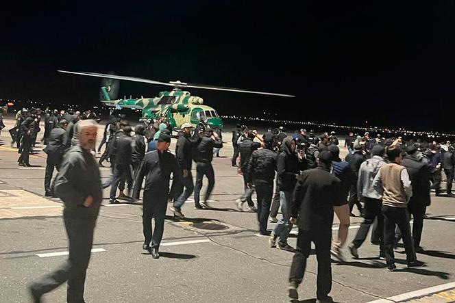 People in the crowd walk shouting antisemitic slogans at an airfield of the airport in Makhachkala, Russia, Sunday, Oct. 29, 2023. 