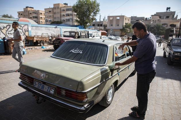 A Palestinian driver uses cooking oil as an alternative fuel in Khan Yunis, southern Gaza Strip, October 30, 2023.