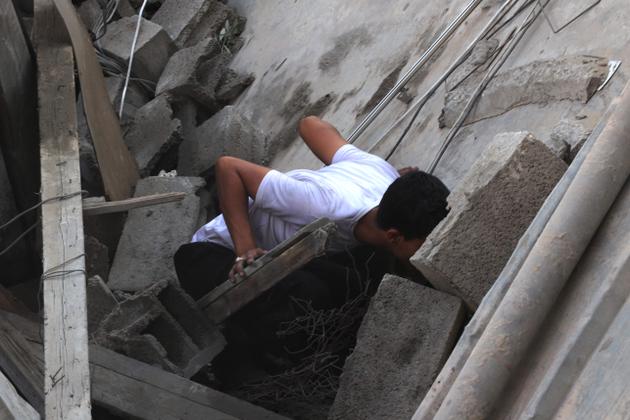 A Palestinian searches through the rubble of a house after an air strike in Rafah, southern Gaza Strip, October 30, 2023.