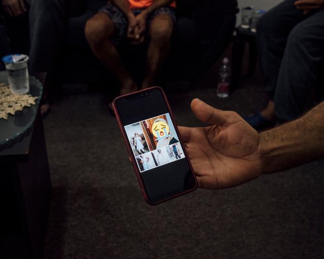 Ahmad Hassuneh shows a photo of his wife and their children, who died on October 22, 2023 in the bombardment of their home in Deir al Balah, Gaza. 
