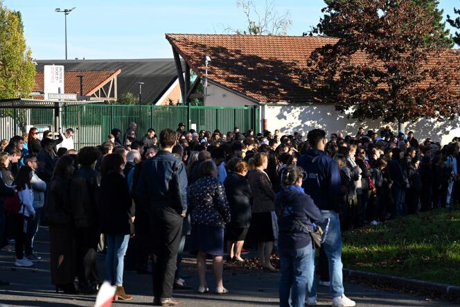 During a minute of silence in tribute to two killed teachers, Samuel Paty and Dominique Bernard, in front of the college where Samuel Paty taught, in Conflans-Sainte-Honorine (Yvelines), on October 16, 2023.