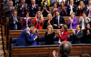 Spain's acting Prime Minister Pedro Sanchez, bottom left, embraces Spain's acting Deputy Prime Minister and Economy Minister Nadia Calvino after he was chosen by a majority of legislators to form a new government after a parliamentary vote at the Spanish Parliament in Madrid, Spain, Thursday, Nov. 16, 2023. (AP Photo/Manu Fernandez)