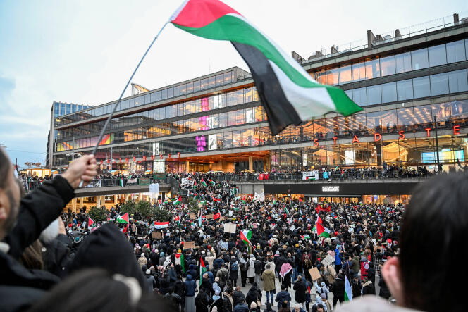 Demonstrators hold Palestinian and Turkish flags and placards during a demonstration in solidarity with Palestinians, at Sergels square in Stockholm, Sweden, October 22, 2023.