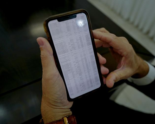 Rabbi Ram Rabat shows on his phone the list of young haredim who have volunteered to join the ranks of the Israeli army, at his home in Petah Tikwa, east of Tel Aviv, on November 16, 2023, Israel.