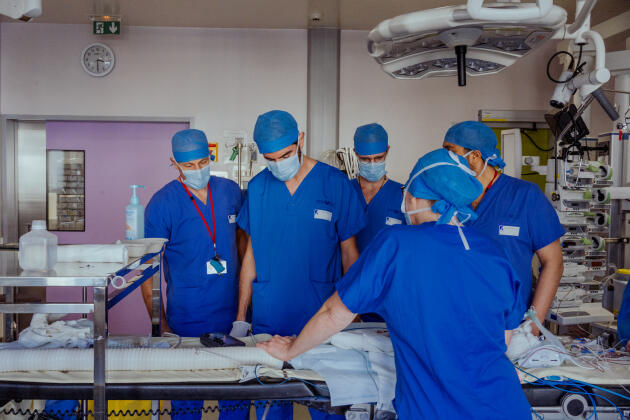 Doctors from the team of surgeon Olivier Raisky at the end of a large vessel transposition operation on a 5-day-old baby, in the operating theater of the Necker-Enfants Malades hospital, in Paris, November 7, 2023.