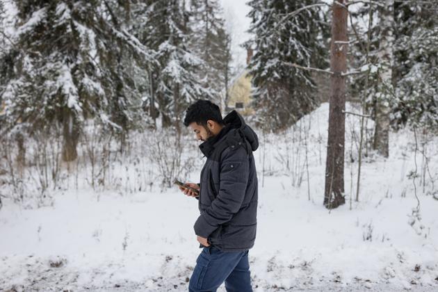 Saleh Almeri, a 26-year-old Yemeni, walks to his accommodation at the Joutseno reception center in the hamlet of Konnunsuo, near Lappeenranta, on November 29, 2023.