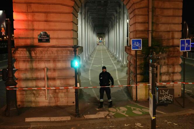 A police officer patrols in a security perimeter set after one person was killed and two others wounded in a knife attack in Paris, on December 2, 2023. 