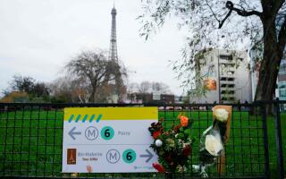 This photograph taken on December 3, 2023 shows flowers where a tourist was stabbed to death on the eve, near the Eiffel Tower (background), in Paris. A person known to the French authorities as a radical Islamist with mental health troubles stabbed a German-Filipino tourist to death and wounded two people in central Paris on December 2, 2023 before being arrested, officials said. (Photo by Dimitar DILKOFF / AFP)