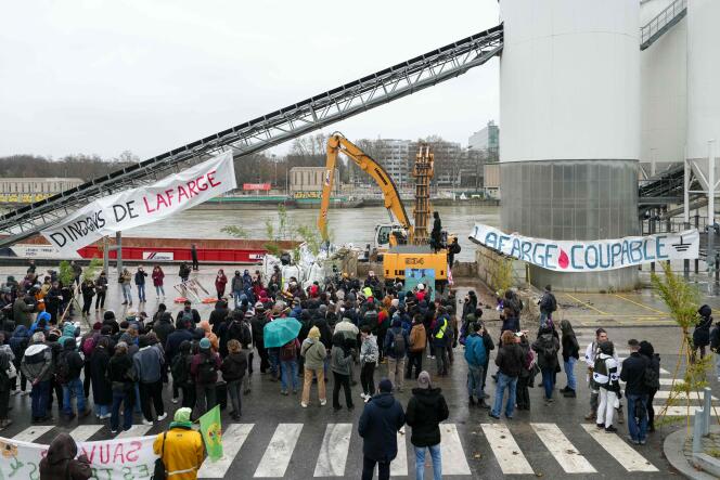 Demonstrators gathered in front of a Lafarge concrete production site in Paris, Sunday December 10, 2023.