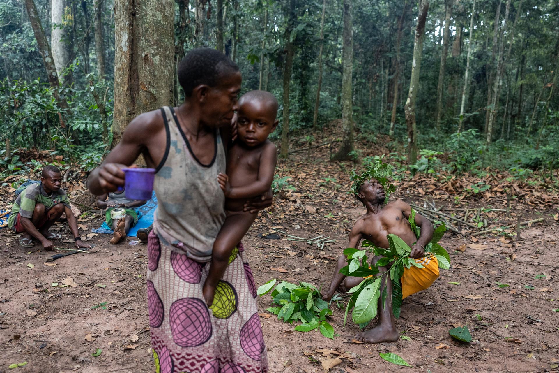 As part of a tourist excursion, members of a Bayaka community perform a traditional dance in their forest camp in the Central African Republic.