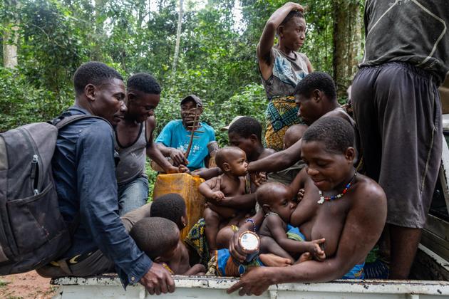 Members of a Bayaka community prepare to leave their forest camp after a tourist excursion in the buffer zone of Dzanga-Sangha National Park, Central African Republic.