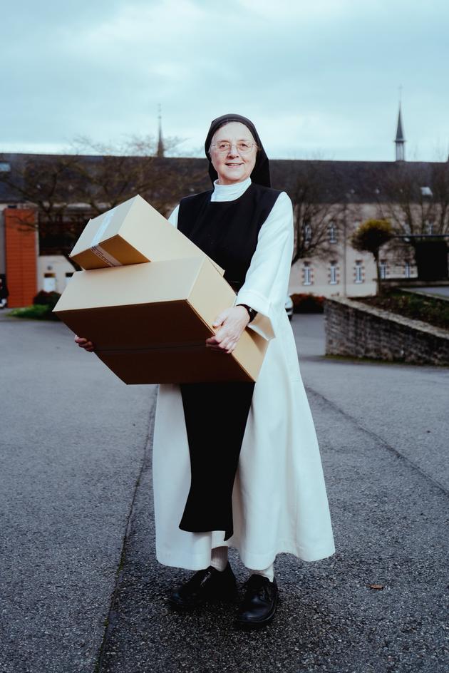 Sales manager Sister Marie-Pierre with boxes of orders at the Abbey de la Coudre in Laval, France, on December 20, 2023.