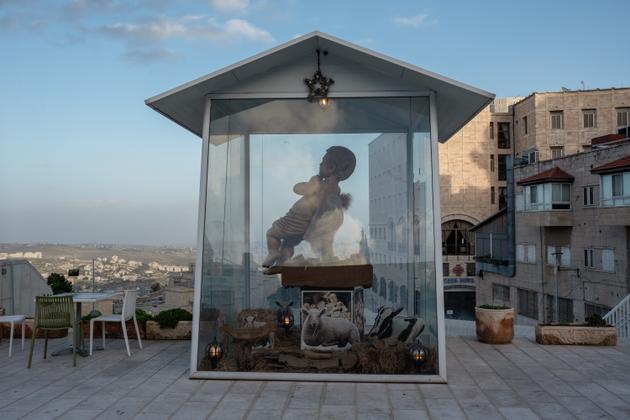 A sculpture of baby Jesus on the empty terrace of a restaurant in Bethlehem, West Bank, December 22, 2023.