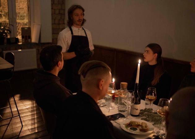 A chef presents his guests with his reimagined Christmas menu, at Kastan, a trendy restaurant in Kyiv, on December 24, 2023. Traditionally, the "sviata vecheria" ("holy dinner") is made up of 12 dishes, the most emblematic of which is "kutia" (a dish based on cereals, berries and dried fruit).