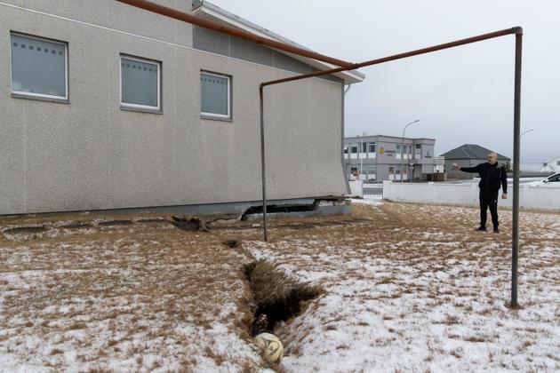 Arnar Olafsson, a resident of Grindavik, Iceland, shows the damage to a house and yard on Vikurbraut Street on December 23, 2023.