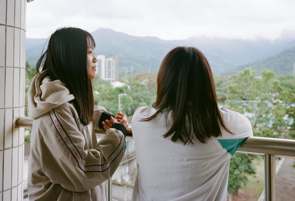 Huang Jia-Ron (L) and Lee Jia-Yan looks at the mountain from 4th floor of National Yuli Senior High School on December 21, 2023 in Yuli, Taiwan.