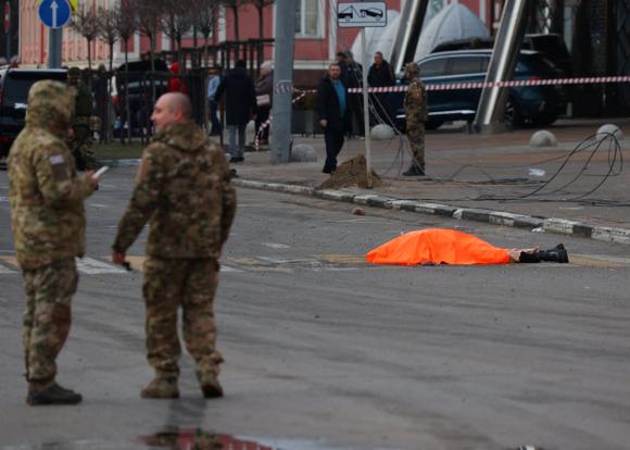 A body is covered on the ground after what Russian authorities say was a Ukrainian military attack, in Belgorod, Russia, December 30, 2023.