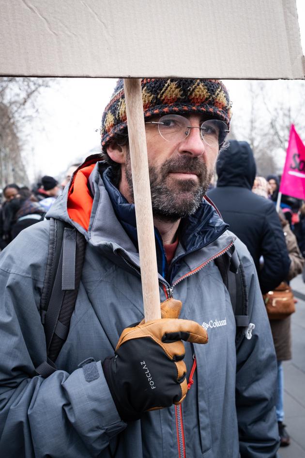 William, in charge of an emergency shelter, in the procession of the demonstration against the "immigration" law, in Paris, January 14, 2024.