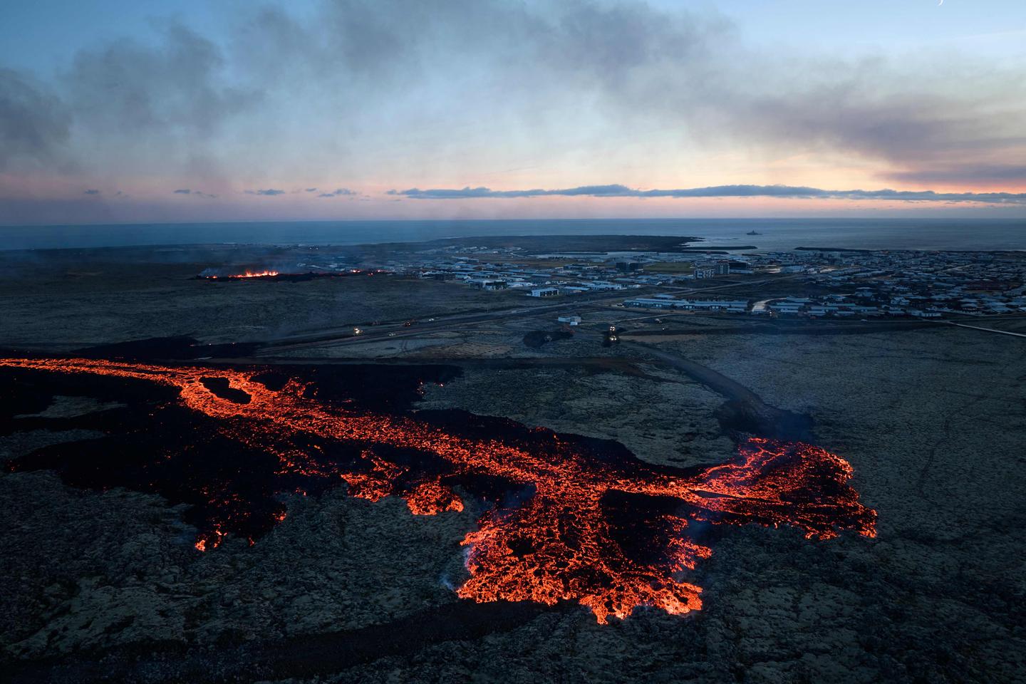 In Iceland, volcano lava flows into a village