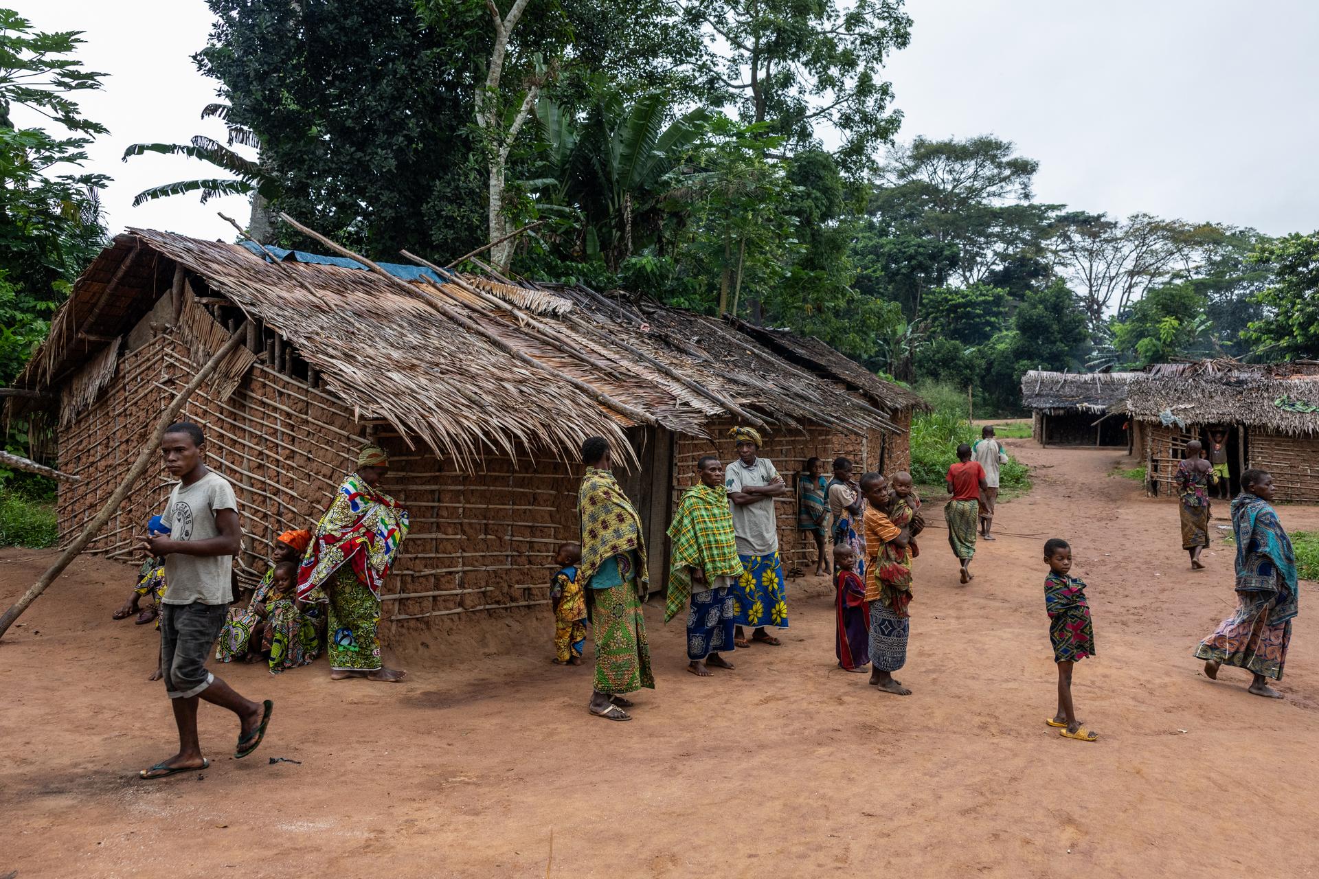 Indigenous people gather before a meeting with the World Wildlife Fund (WWF) in the village of Yandombe, on the edge of Dzanga-Sangha National Park, Central African Republic.