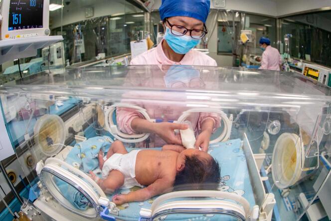 Pielęgniarka opiekuje się noworodkiem w szpitalu w Taizhou, w prowincji Jiangsu we wschodnich Chinach, 12 maja 2023 r.