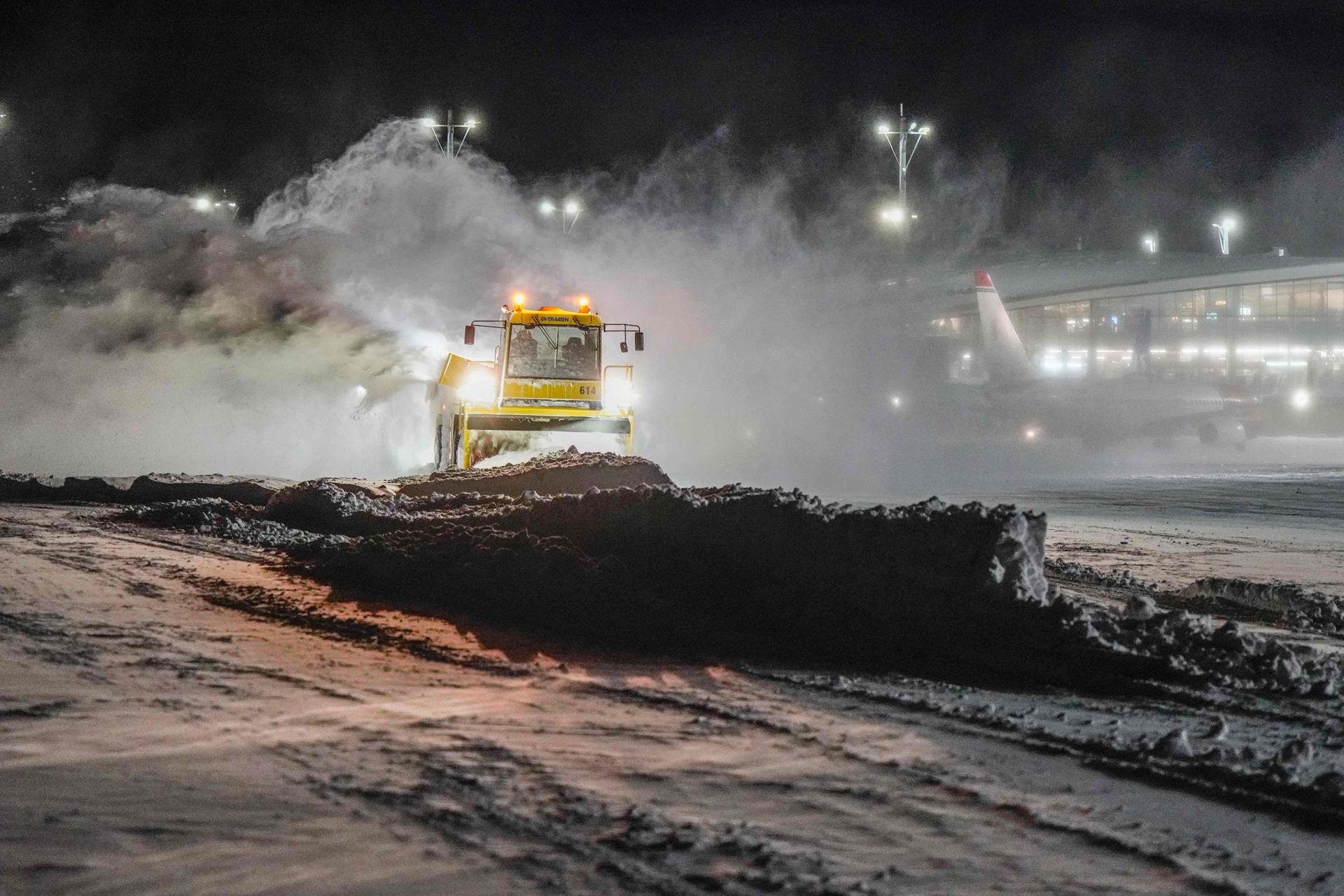 A snow plough pushes snow at Oslo Airport in Gardermoen on January 17, 2024. 
