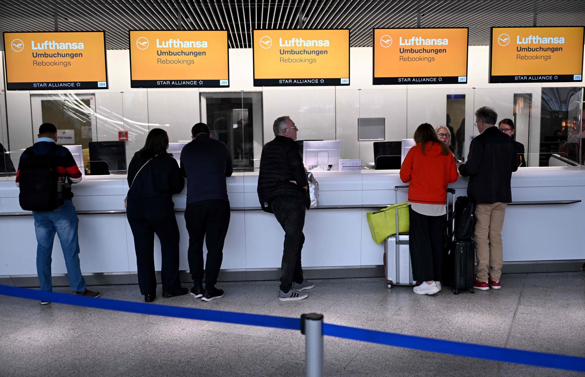 Passengers rebook their flights at the airport in Frankfurt am Main, western Germany, on January 17, 2024, as severe winter weather warnings prompted the cancellation of hundreds of flights. 