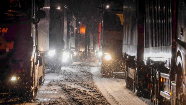 Trucks are jammed on the snow-covered A5 highway near Grünberg, Germany, Wednesday, Jan. 17, 2024. Traffic backed up in the snow on A4, A5 and A7 highways in eastern Hesse. 