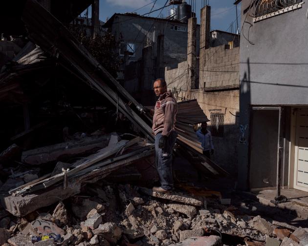 Hussein Moussa Alajma stands on the rubble of his house, destroyed during an Israeli army operation, in the Nur Shams refugee camp in the West Bank on January 19, 2024.