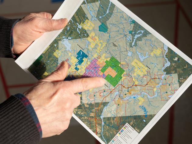 Gilbert Guérin, the president of Creuse pas dans mon Caxton, showing details of problematic mining claims on a map in Saint-Elie-de-Caxton, Québec, on January 17, 2024.